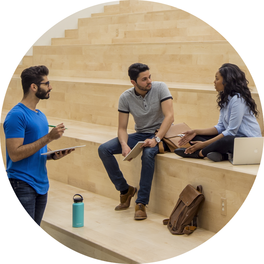 Image of three people talking on wooden benches