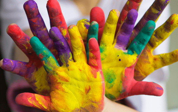 Image of children's hands with multicolor paint