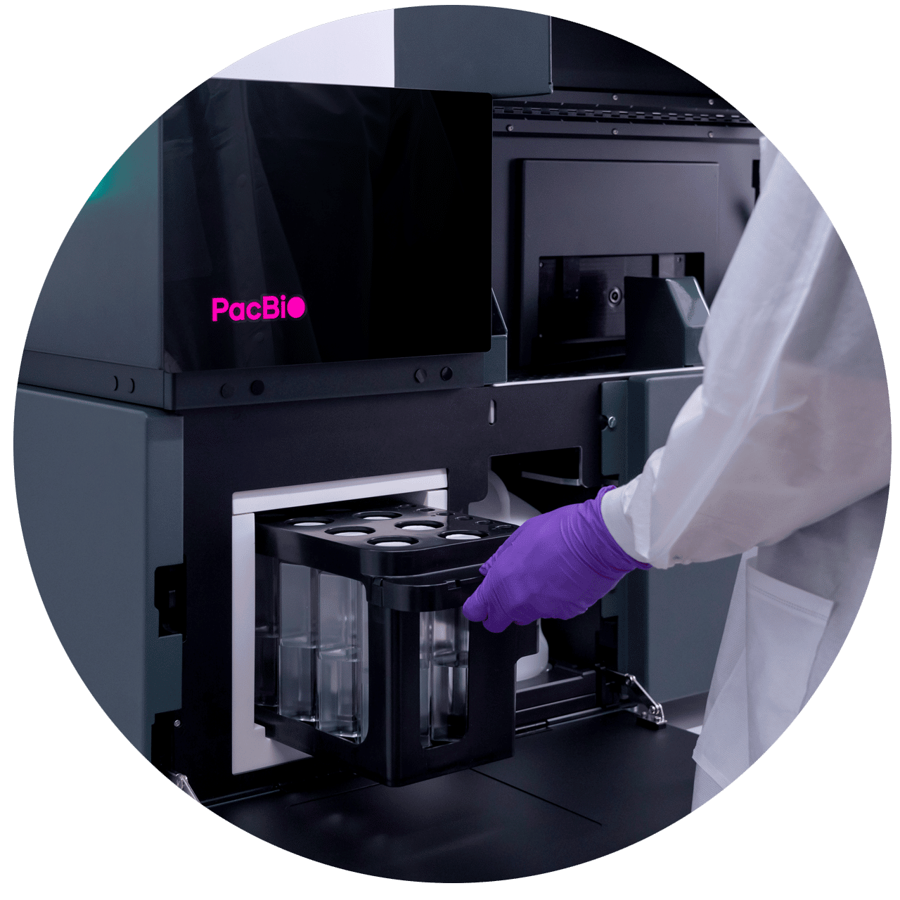 Roundel image of user inserting tray into Onso system sequencer - PacBio